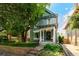 Charming two-story home with a manicured front yard and a beautiful mature tree at 1429 Josephine St, Denver, CO 80206