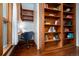 Cozy home office space featuring custom wood shelving, a desk, and a comfortable blue chair at 1429 Josephine St, Denver, CO 80206