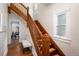 Beautiful wood staircase with decorative banister and trim and a sunlit landing at 1429 Josephine St, Denver, CO 80206