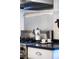 Close-up of stovetop, showcasing stainless steel range, tile backsplash, and a sleek design at 1429 Josephine St, Denver, CO 80206