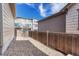 The backyard is fenced with a rock ground cover and surrounded by neighboring townhomes at 3793 Cadence Dr, Castle Rock, CO 80109