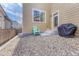 Enclosed backyard with gravel and chairs; a grill and an entrance to the residence at 3793 Cadence Dr, Castle Rock, CO 80109