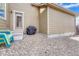 Enclosed patio area features gravel ground cover and includes a black grill and colorful chairs at 3793 Cadence Dr, Castle Rock, CO 80109