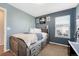 Cozy bedroom featuring blue walls, carpet, a bed with storage drawers, and a window for natural light at 3793 Cadence Dr, Castle Rock, CO 80109
