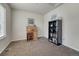 A bedroom featuring carpeted floors and a bookcase near a roll top desk with chair at 3793 Cadence Dr, Castle Rock, CO 80109