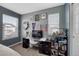 Bedroom featuring blue walls, carpet, a desk, and a window for natural light, creating a workspace at 3793 Cadence Dr, Castle Rock, CO 80109