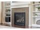 Close-up of fireplace with decorative tile surround and built-in shelving at 3793 Cadence Dr, Castle Rock, CO 80109