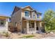 Inviting two-story home featuring a cozy front porch, neat landscaping, and a welcoming facade at 3793 Cadence Dr, Castle Rock, CO 80109
