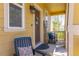 Charming front porch with comfortable seating, a welcoming 'hello' wreath, and natural light at 3793 Cadence Dr, Castle Rock, CO 80109
