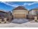 View of the two car garage with a concrete driveway and tasteful landscaping on both sides at 3793 Cadence Dr, Castle Rock, CO 80109