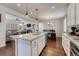 Open-concept kitchen boasts granite countertops, a spacious island, and seamless flow into the living and dining areas at 3793 Cadence Dr, Castle Rock, CO 80109