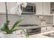 Close-up of modern kitchen with stainless steel appliances and subway tile backsplash at 3793 Cadence Dr, Castle Rock, CO 80109