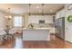 Well-lit kitchen with white cabinetry, stainless steel appliances, and granite island at 3793 Cadence Dr, Castle Rock, CO 80109