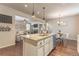 Open kitchen and living area with center island, stainless steel appliances, and plenty of seating at 3793 Cadence Dr, Castle Rock, CO 80109