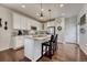 Bright kitchen featuring white cabinets, granite countertops, stainless steel appliances, and an island with seating at 3793 Cadence Dr, Castle Rock, CO 80109