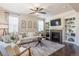 Comfortable living room featuring a fireplace, built-ins, and natural light at 3793 Cadence Dr, Castle Rock, CO 80109