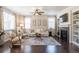 Comfortable living room featuring a fireplace, built-ins, and natural light at 3793 Cadence Dr, Castle Rock, CO 80109