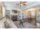 Open-concept living room with fireplace, built-in shelves, and adjacent dining area at 3793 Cadence Dr, Castle Rock, CO 80109