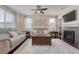Inviting living room with a fireplace, hardwood floors, stylish furniture, and a ceiling fan at 3793 Cadence Dr, Castle Rock, CO 80109