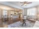 Open-concept living room with hardwood floors, seamlessly connecting to the kitchen and dining area at 3793 Cadence Dr, Castle Rock, CO 80109
