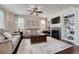 Bright living room with hardwood floors, built-in bookshelves, a fireplace, and neutral decor at 3793 Cadence Dr, Castle Rock, CO 80109