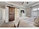 Spacious main bedroom boasts tray ceiling, ceiling fan and attached bath with sliding barn door at 3793 Cadence Dr, Castle Rock, CO 80109