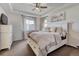 Bright bedroom with ceiling fan, dresser, and decorative artwork at 3793 Cadence Dr, Castle Rock, CO 80109