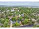 Expansive aerial view of tree-lined neighborhood showcasing many homes and landscape at 5553 S Datura St, Littleton, CO 80120