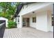 Back porch with a grey wood floor and sliding doors at 5553 S Datura St, Littleton, CO 80120