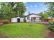 Landscaped backyard featuring a shed, deck, and lush lawn at 5553 S Datura St, Littleton, CO 80120