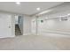 Spacious unfinished basement with carpeting offering potential for customization at 5553 S Datura St, Littleton, CO 80120