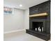 Basement fireplace with painted brick, a wooden mantel, and a window at 5553 S Datura St, Littleton, CO 80120