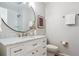 Well-lit bathroom featuring a marble vanity, modern fixtures, and ample storage space at 5553 S Datura St, Littleton, CO 80120