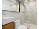 Updated bathroom with a glass-enclosed shower and modern vanity at 5553 S Datura St, Littleton, CO 80120