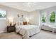 Serene bedroom with light walls, large windows, and comfortable bedding for a peaceful retreat at 5553 S Datura St, Littleton, CO 80120