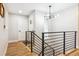 Modern entryway with wood floors, sleek railings and stylish light fixture at 5553 S Datura St, Littleton, CO 80120