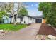 Beautiful one-story home with a private driveway and well-maintained lawn at 5553 S Datura St, Littleton, CO 80120