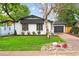 Charming home featuring a well-manicured lawn and rock garden at 5553 S Datura St, Littleton, CO 80120