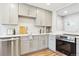 Well-equipped kitchen featuring grey cabinetry and modern stainless steel appliances at 5553 S Datura St, Littleton, CO 80120