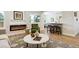 Cozy living room adjacent to an open kitchen and dining area at 5553 S Datura St, Littleton, CO 80120