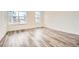 Bright bedroom featuring large windows and stylish wood-look flooring at 918 Promenade Dr, Superior, CO 80027