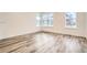 Bright bedroom featuring large windows and stylish wood-look flooring at 918 Promenade Dr, Superior, CO 80027
