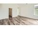 Empty bedroom with wood-look floors, white walls, and two doors at 918 Promenade Dr, Superior, CO 80027
