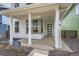 Inviting front porch with white columns and a modern front door at 918 Promenade Dr, Superior, CO 80027