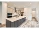 Modern kitchen featuring an oversized island with a marbled countertop and stainless steel appliances at 918 Promenade Dr, Superior, CO 80027