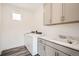 Laundry room featuring washer, dryer, sink, and storage cabinets at 918 Promenade Dr, Superior, CO 80027