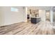 Open-concept living area leading to a modern kitchen, featuring stylish wood-look floors at 918 Promenade Dr, Superior, CO 80027