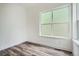 Bright room with wood-look flooring, white walls, and a large window at 918 Promenade Dr, Superior, CO 80027