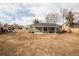 View of the home from the backyard with large open space at 1150 S Taos Way, Denver, CO 80223
