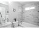 Modern bathroom with a shower over the tub and stylish gray-and-white tile at 1150 S Taos Way, Denver, CO 80223